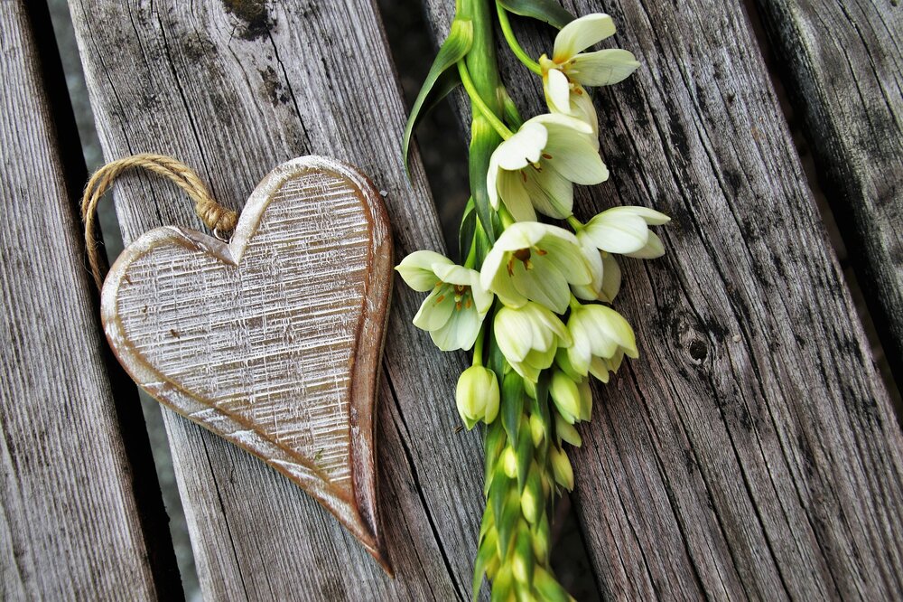 Flower And Heart Locket On Wood Plank